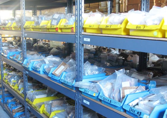 storage shelves with plastic boxes holding aircraft parts