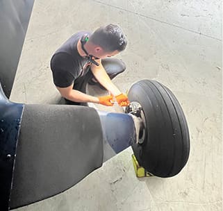 mechanic working on the landing gear.